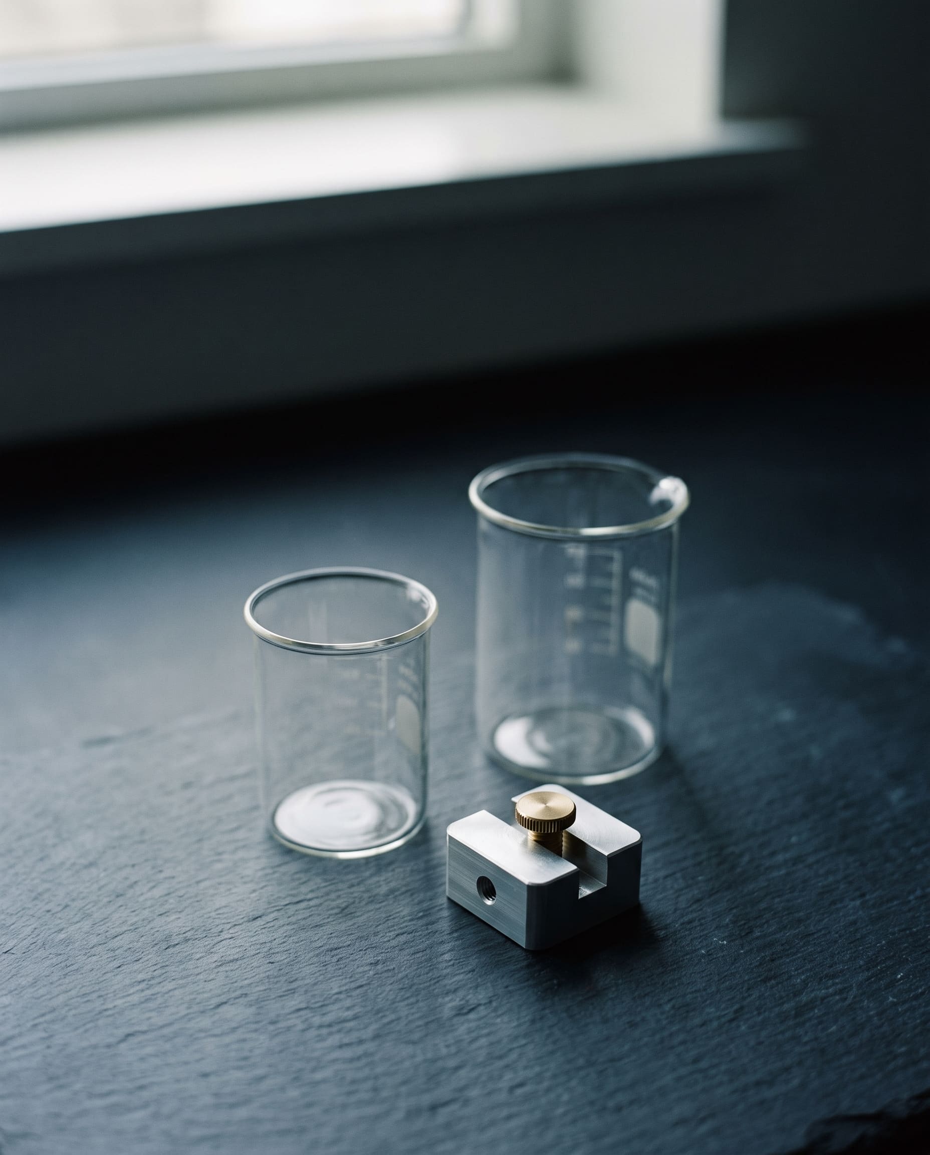 Laboratory glass and a metal fixture in low light